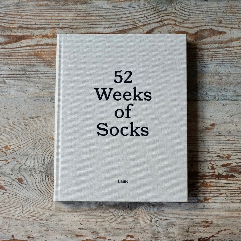 52 weeks of socks book by Laine on a wooden background