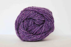 A purple ball of yarn 2 ply by Jamieson and Smith on a white background
